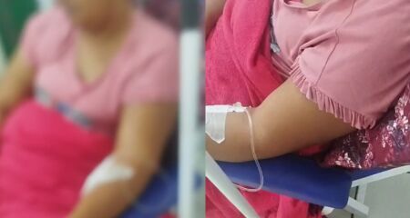 Família relata que jovem sente fortes dores, está em cadeira por falta de leito e entrou na justiça para tentar transferência